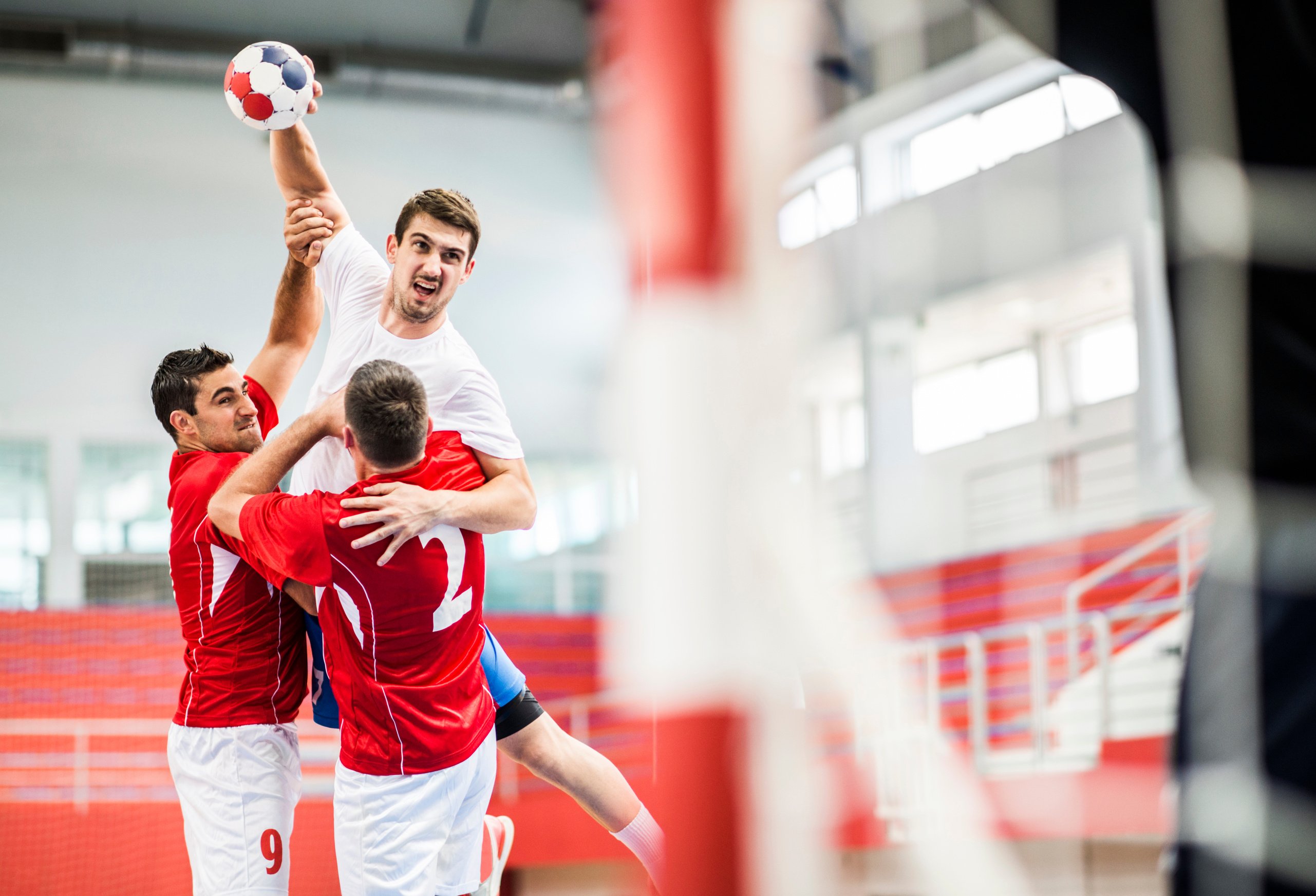 Handball player shooting at goal.